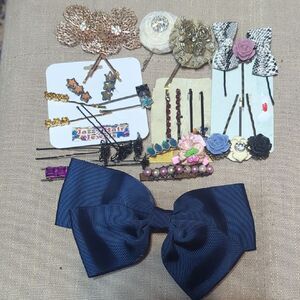 various hair accessories, including hair clips, bobby pins, and decorative bows.